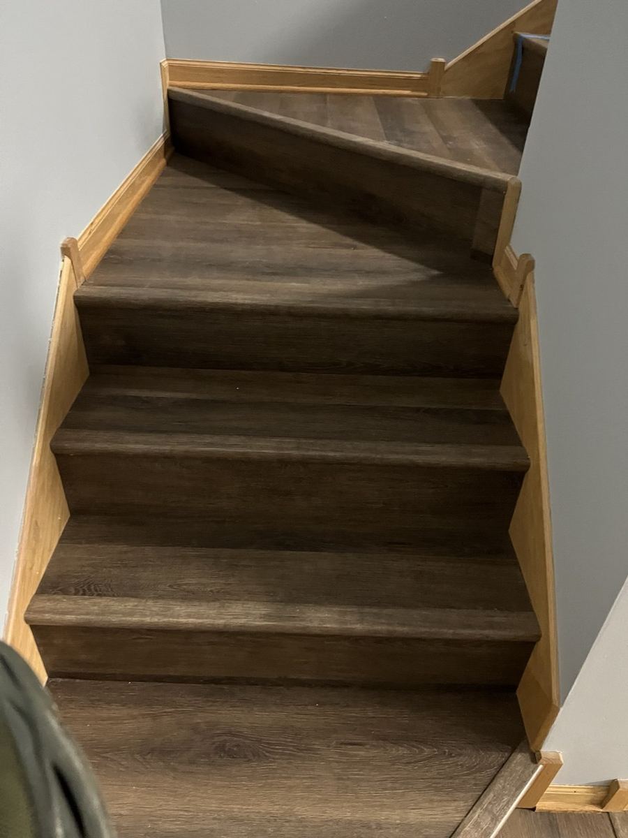 After — dark oak LVP winder stairs