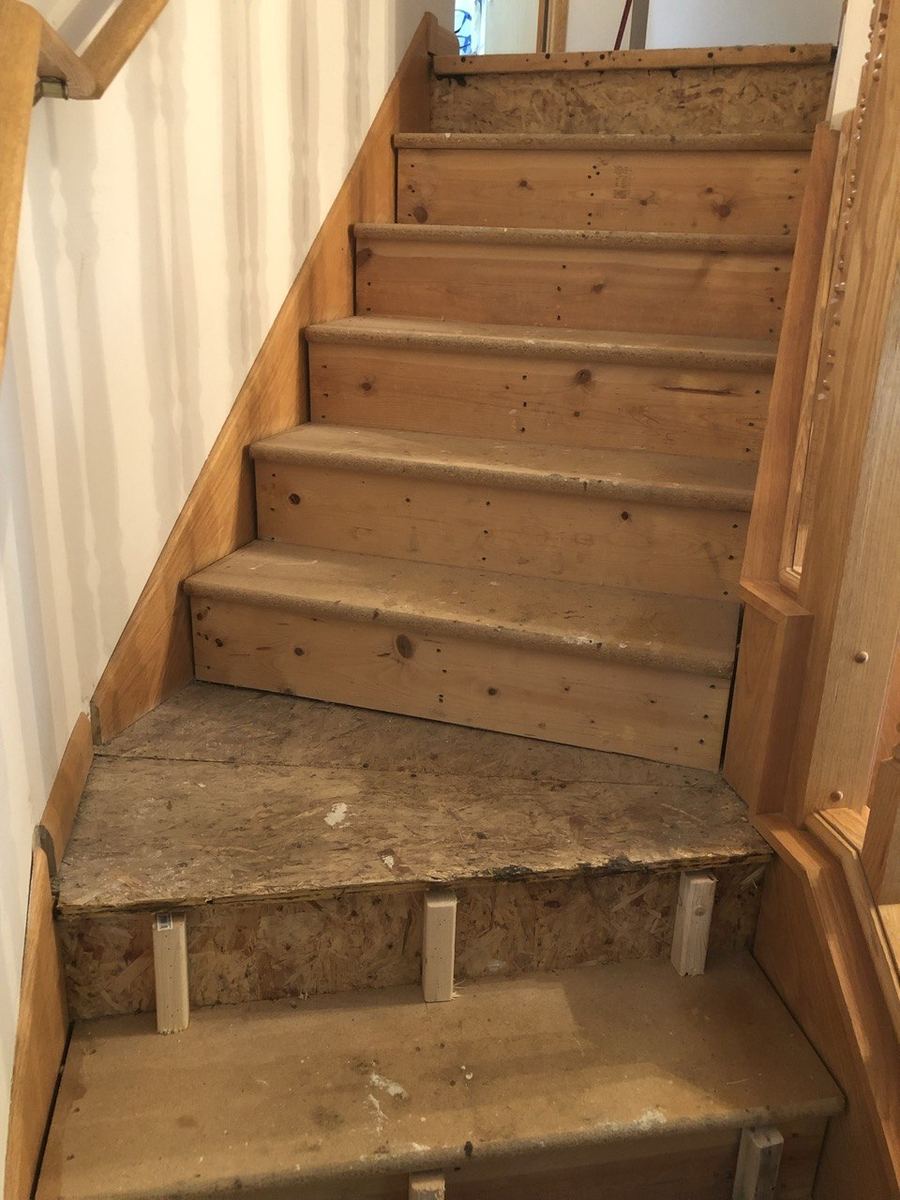 Before — bare pine stairs