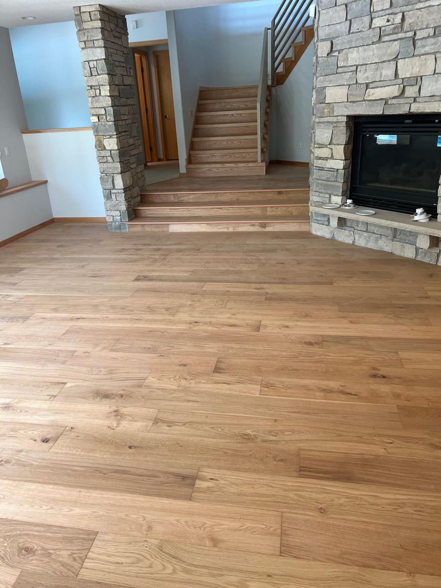 White oak hardwood great room with stone fireplace