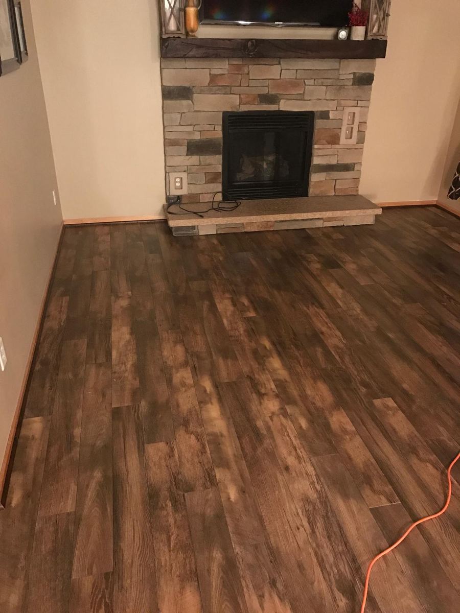 Barnwood laminate living room with stone fireplace
