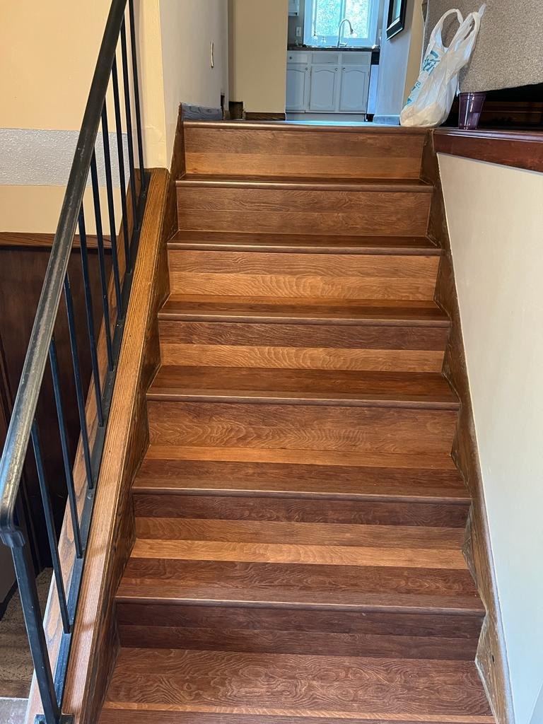 Two-tone hickory stairs with iron railing